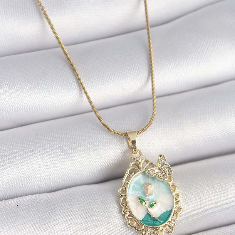 316L Çelik Gold Renk Zincir Mavi Mineli Çiçek İşlemeli Zirkon Taş Detaylı Portre Model Kadın Kolye